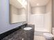 Bathroom with granite countertop, white sink, and a bathtub/shower combo at 1143 N College Ave, Newton, NC 28658