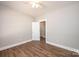 A bright bedroom features durable wood-look floors and a neutral color palette at 1143 N College Ave, Newton, NC 28658