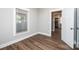 Bedroom with wood-look floors, a window, and a view into the kitchen at 1143 N College Ave, Newton, NC 28658