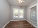 Bedroom with a window with blinds and wood-look floors at 1143 N College Ave, Newton, NC 28658