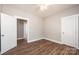 This bedroom has wood-look floors, white trim and doors, and a ceiling fan at 1143 N College Ave, Newton, NC 28658