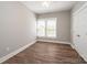 Bedroom with a closet with double doors, and a window with blinds at 1143 N College Ave, Newton, NC 28658