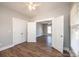 A bright bedroom features wood-look floors, ceiling fan, and spacious closet space at 1143 N College Ave, Newton, NC 28658
