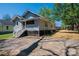 Charming home featuring a cozy front porch and fresh landscaping, inviting outdoor living at 1143 N College Ave, Newton, NC 28658