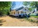 Charming gray home featuring a welcoming front porch with black and white accents at 1143 N College Ave, Newton, NC 28658