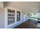 Charming covered porch with wood floors and a view of the surrounding neighborhood at 1143 N College Ave, Newton, NC 28658