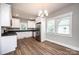 Modern kitchen features stainless steel appliances, white cabinetry, and granite counters at 1143 N College Ave, Newton, NC 28658
