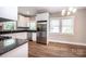 Modern kitchen features stainless steel appliances, white cabinetry, and granite counters at 1143 N College Ave, Newton, NC 28658
