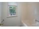 Well-lit bathroom features a tiled shower and bright window with green views at 1228 Quiet Acres Rd, Rock Hill, SC 29732