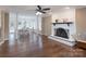 Spacious living room with a fireplace, hardwood floors, ceiling fan, and access to the dining area at 1228 Quiet Acres Rd, Rock Hill, SC 29732