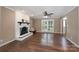 Cozy living room with a white brick fireplace and hardwood flooring at 1228 Quiet Acres Rd, Rock Hill, SC 29732