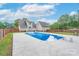 Large in-ground swimming pool with concrete patio and fully fenced yard at 1228 Quiet Acres Rd, Rock Hill, SC 29732