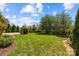 Expansive backyard features lush lawn and landscaped garden beds, creating a serene outdoor space at 12614 Robert Walker Dr, Davidson, NC 28036