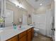 Bathroom featuring a single sink vanity, updated lighting and a shower-tub combo at 12614 Robert Walker Dr, Davidson, NC 28036