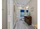 Well-lit bathroom features a tub with shower, a sink with dark wood cabinets, and wood-look flooring at 12614 Robert Walker Dr, Davidson, NC 28036