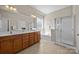 Bathroom featuring a double sink vanity, soaking tub and glass shower at 12614 Robert Walker Dr, Davidson, NC 28036