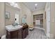 Bathroom with spacious vanity, open storage, and grey wood flooring provides a clean, modern space at 12614 Robert Walker Dr, Davidson, NC 28036