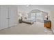 Bright bedroom features a cozy bed, neutral walls, and plenty of natural light from the windows at 12614 Robert Walker Dr, Davidson, NC 28036