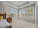 Bright bedroom featuring large windows with plantation shutters and neutral decor at 12614 Robert Walker Dr, Davidson, NC 28036