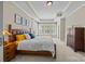 Comfortable bedroom with tray ceiling, shutters, and dresser at 12614 Robert Walker Dr, Davidson, NC 28036