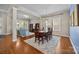 Open dining room with hardwood floors, stylish lighting, and open access to the living room at 12614 Robert Walker Dr, Davidson, NC 28036