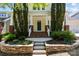 Inviting front porch with a brick entryway and nicely landscaped garden at the front of the home at 12614 Robert Walker Dr, Davidson, NC 28036