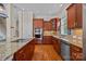 Kitchen with stainless steel appliances, granite counters, and dark wood cabinets at 12614 Robert Walker Dr, Davidson, NC 28036
