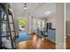 Cozy living room with hardwood floors, bookshelves, and an open entryway at 12614 Robert Walker Dr, Davidson, NC 28036
