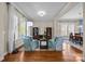 Bright living room with hardwood floors, bookshelves, and open access to the dining area at 12614 Robert Walker Dr, Davidson, NC 28036
