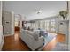 Spacious living room featuring hardwood floors, fireplace, and oversized windows at 12614 Robert Walker Dr, Davidson, NC 28036