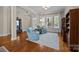 Sunlit living room with hardwood floors and comfortable seating next to an open entryway at 12614 Robert Walker Dr, Davidson, NC 28036