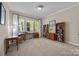 Home office featuring a work space, multiple bookshelves, and natural light at 12614 Robert Walker Dr, Davidson, NC 28036