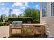 An outdoor kitchen with a grill and stainless-steel cabinets offers a perfect space for outdoor cooking at 12614 Robert Walker Dr, Davidson, NC 28036