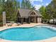 Community pool with inviting clear water, lounge chairs, and a well-equipped pool house at 12614 Robert Walker Dr, Davidson, NC 28036