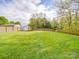 Expansive backyard featuring a lush lawn, shed, and privacy fence perfect for outdoor activities at 1315 Holshouser Rd, Rockwell, NC 28138