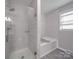 Bathroom showcasing the tiled shower with glass door and a white tub at 1315 Holshouser Rd, Rockwell, NC 28138