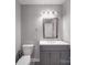Bathroom has gray vanity, framed mirror, and lighting at 1315 Holshouser Rd, Rockwell, NC 28138