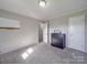 A carpeted bedroom with paneled walls features a whiteboard, dresser, and closet for optimal storage and organization at 1315 Holshouser Rd, Rockwell, NC 28138