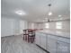 Modern kitchen with granite counters, grey cabinets, a large island with bar stool seating and stainless appliances at 1315 Holshouser Rd, Rockwell, NC 28138