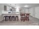 Modern kitchen with stainless appliances, granite countertops, island with bar stools, light gray cabinetry at 1315 Holshouser Rd, Rockwell, NC 28138