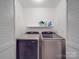 Convenient laundry area featuring a side-by-side washer and dryer and built-in shelving at 1315 Holshouser Rd, Rockwell, NC 28138