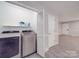 Laundry room featuring a washer/dryer and utility storage with shelving at 1315 Holshouser Rd, Rockwell, NC 28138