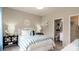 Bright bedroom with a bed featuring blue and white striped comforter, lamps, and ensuite bathroom at 13304 Chopin Ridge Dr, Huntersville, NC 28078