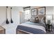 Comfortable bedroom with a striped comforter bed, window, and artwork on the wall, creating a cozy retreat at 13304 Chopin Ridge Dr, Huntersville, NC 28078