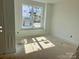 Bedroom with white walls, a large window for natural light, and neutral flooring at 13304 Chopin Ridge Dr, Huntersville, NC 28078