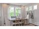 Bright dining room with modern chandelier lighting, neutral paint, and views of the outdoors at 13304 Chopin Ridge Dr, Huntersville, NC 28078