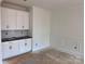 Bright dining room showcases classic wainscoting and ample cabinet space for storage and display at 13304 Chopin Ridge Dr, Huntersville, NC 28078