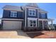 A charming new construction two-story home features a two car garage and a brick foundation at 13304 Chopin Ridge Dr, Huntersville, NC 28078