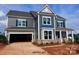 New construction, two-story home features a gray siding, brick base, and an attached two-car garage at 13304 Chopin Ridge Dr, Huntersville, NC 28078