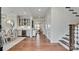 Elegant foyer with hardwood floors, a dining table, and staircase leading to the upper level at 13304 Chopin Ridge Dr, Huntersville, NC 28078
